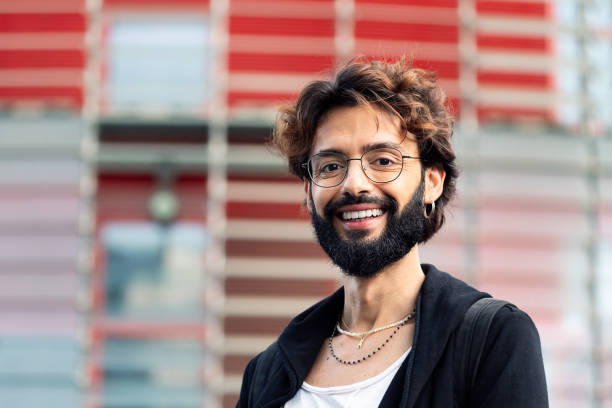 istock smiling young man with glasses and beard 1413909000