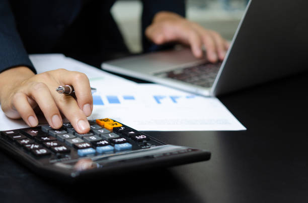 istock Business document finance report and accounting analysis graph.Businessman using calculate marketing investment chart paperwork statistic on desk. 1413909010