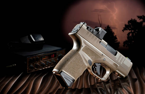 istock Handgun and cb radio with lightning storm behind 1413911668