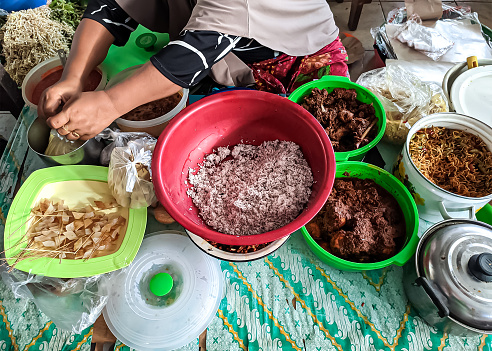 a side dish seller in a traditional market serving buyers