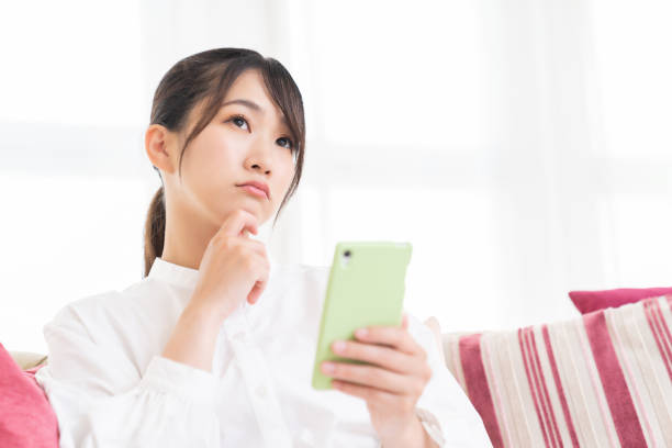istock attractive Asian woman using a smart phone,think, 1413919172