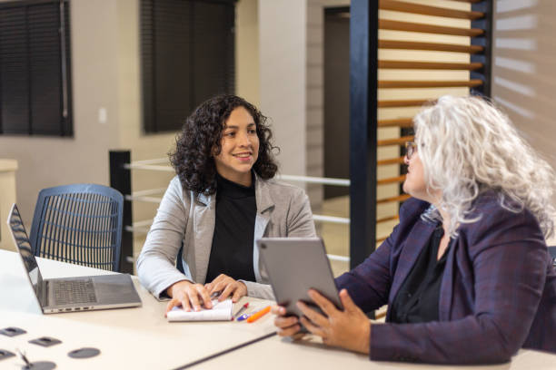 istock Women in office work with laptop and tablet 1413920890