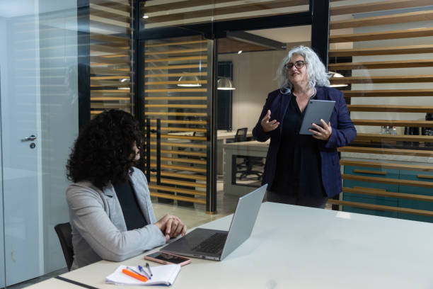 istock Middle-aged woman at an office presentation 1413922418