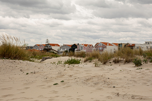 Costa Nova is a delightful village famed for its magnificent sandy coast line and colorful beach houses. Costa Nova, Portugal.