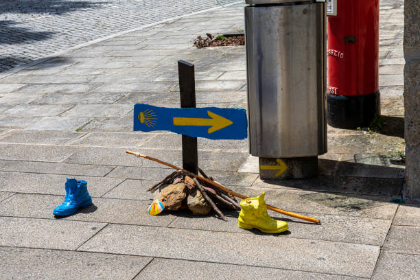 Camino de Santiago milestones, walking and cycling pilgrimage, scallop shell and yellow arrow are symbols of this ancient pilgrimage route, UNESCO world heritage site.