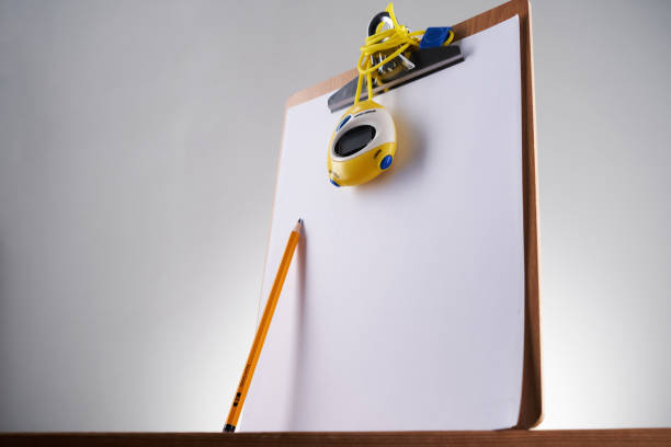 clipboard with stop watch and pencilagainst white background