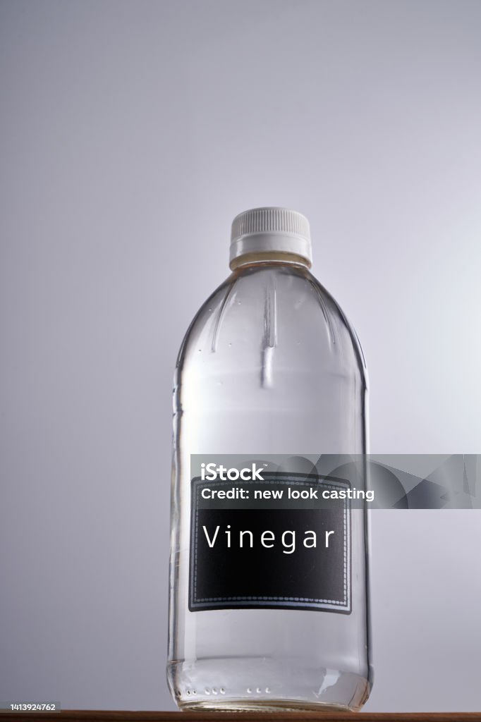 white vinegar against gray white background Bottle Stock Photo