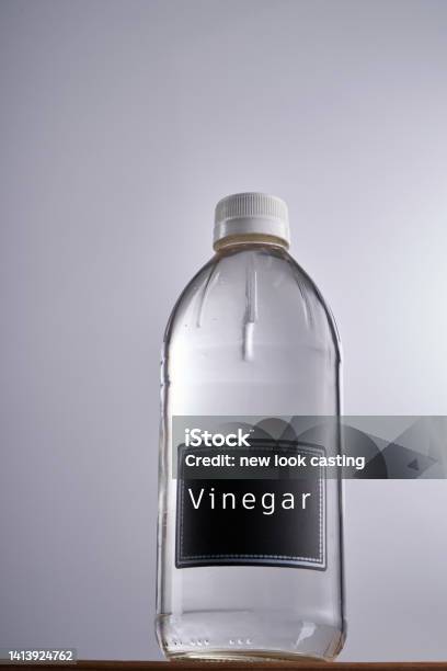 White Vinegar Against Gray White Background Stock Photo - Download Image Now - Bottle, Vinegar, White Vinegar