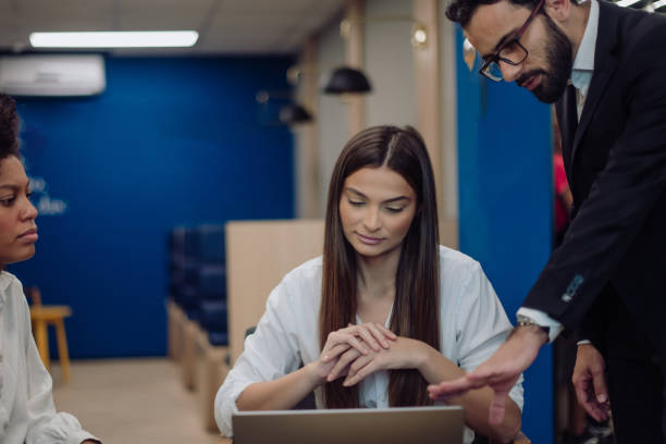 istock man talking to coworkers 1413930046
