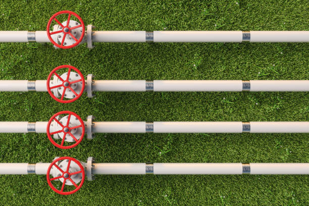 aerial view of gas or pipe line valves on grass - water valve oil gas imagens e fotografias de stock