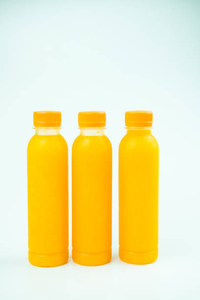 istock Three bottles of delicious orange juice 1413935249