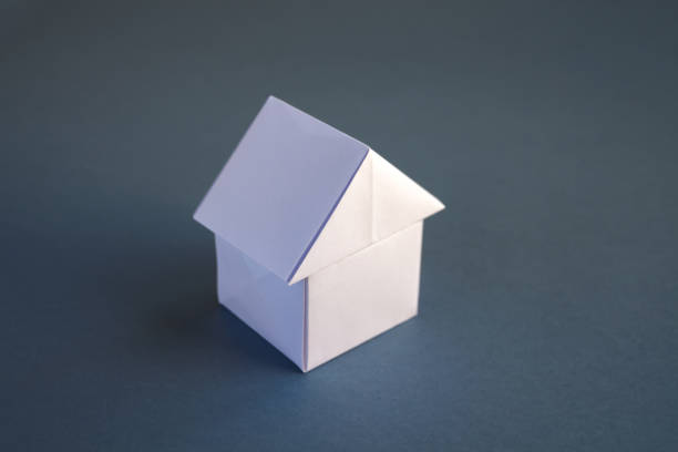 istock White paper house origami isolated on a grey background 1413944568
