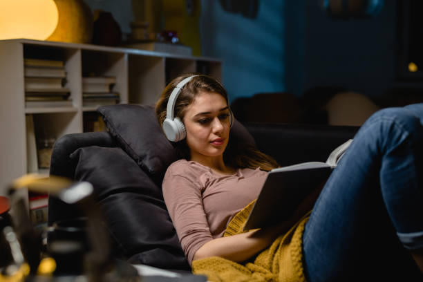 istock woman relaxing at home. evening scene 1413946723