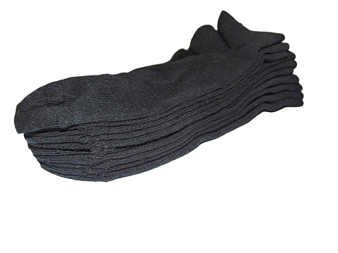 several pairs of new black socks isolated on white