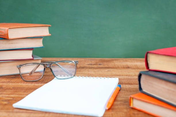 istock glasses, books and a notebook lie on a wooden table 1413960713