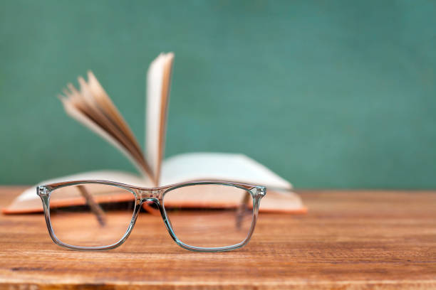 istock glasses on the background of an open book 1413961573