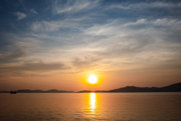 istock sunset view above sea with mountain and nice sky 1413962016