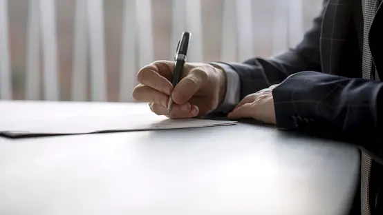 probate in texas is a multifaceted legal process, man signing a document in a law office or at a notarys table close up of document signing and