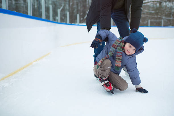 istock Father teaching his little boy to ice-skate outdoors in winter 1413966876
