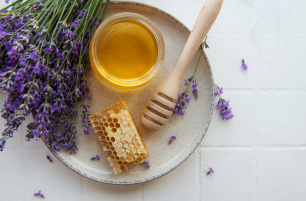 istock Jar with honey and fresh lavender flowers 1413967543