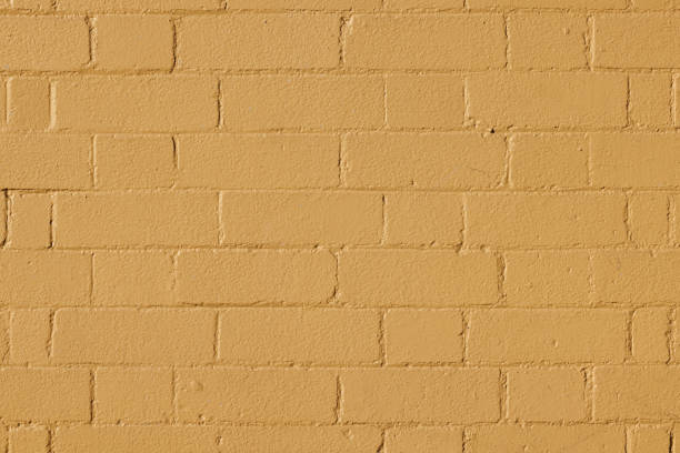 Close-up on an old painted brick wall.