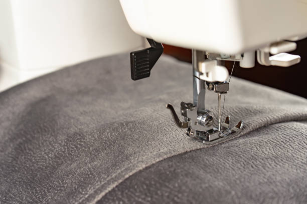 istock Modern sewing machine and gray fabric. Sewing process, handmade, hobby, DIY, business, repair 1413971764
