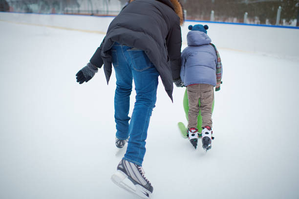 istock Father teaching his little boy to ice-skate outdoors in winter 1413973594