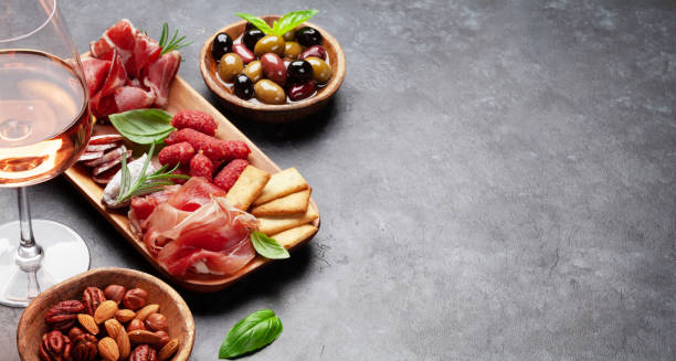 istock Antipasto board with prosciutto, salami, crackers, cheese, olives 1413974093