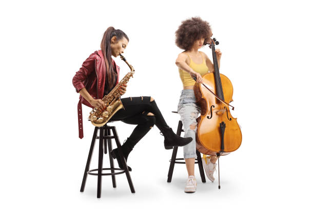 istock Two young women playing a cello and a sax 1413974850