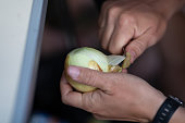 A man peels onions