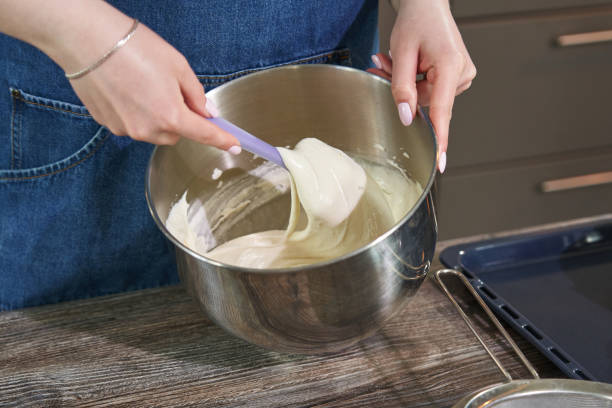 istock female hand kneading the dough in a bowl with a spatula 1413977115