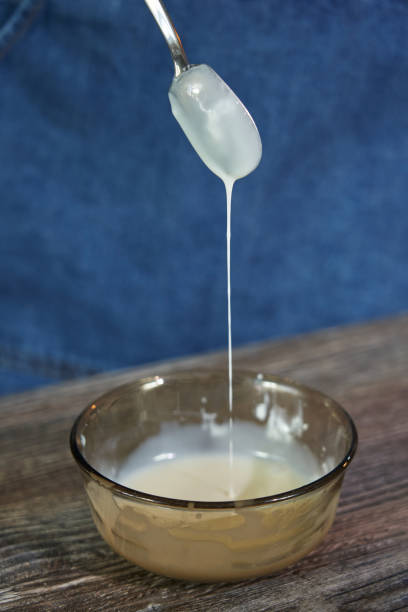 istock liquid white chocolate flows down a teaspoon in a thin stream to decorate the cake 1413977252