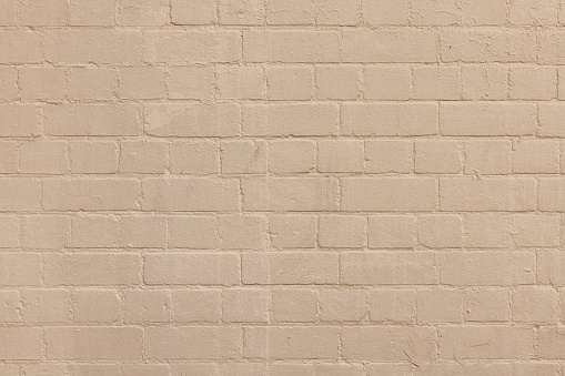 Close-up on an old painted brick wall.