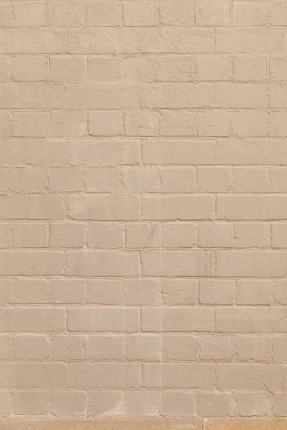 istock Part of a painted old beige brick wall 1413977377