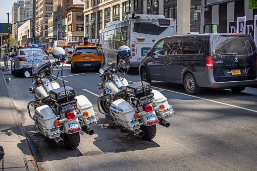 Midtown Manhattan, New York, NY, USA - July 1, 2022: Two parked police motorbikes on 7th Avenue close to West 31th Street on a sunny day