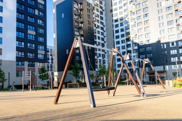Swings on the empty kids children playground courtyard