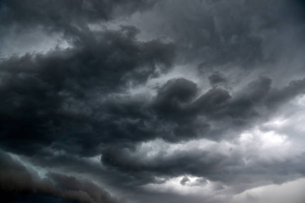 istock Black thunderstorm storm clouds on a summer day. Beautiful terrible thunderstorm. 1413984494