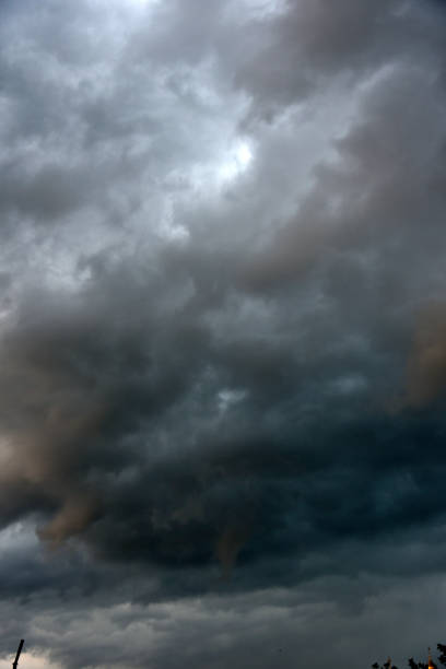 istock Black thunderstorm storm clouds on a summer day. Beautiful terrible thunderstorm. 1413984522