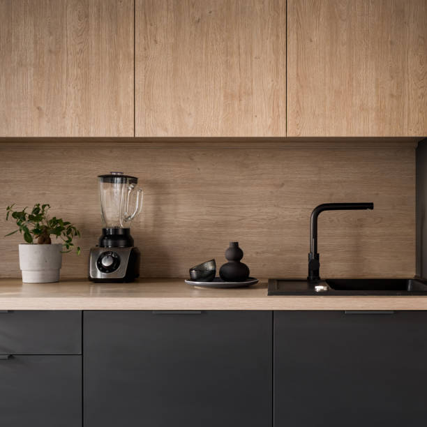 istock Kitchen countertop with black sink, close-up 1413985083
