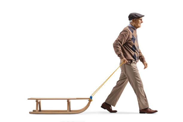 istock Full length profile shot of a senior man walking and pulling a sled 1413986434