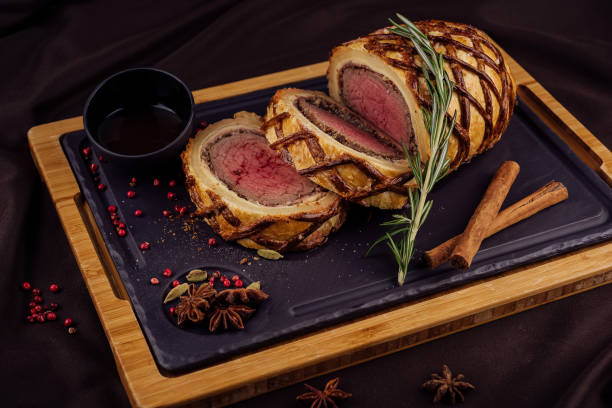 istock Beef tenderloin rolls stuffed on wooden board 1413986711