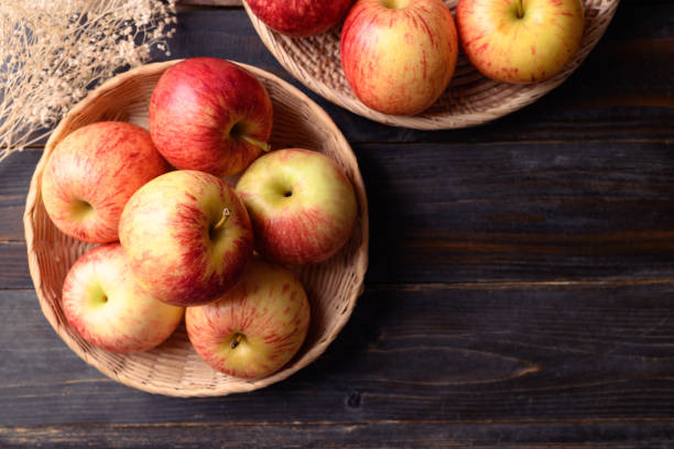 istock Red apple fruit on wooden background, top view 1413987915