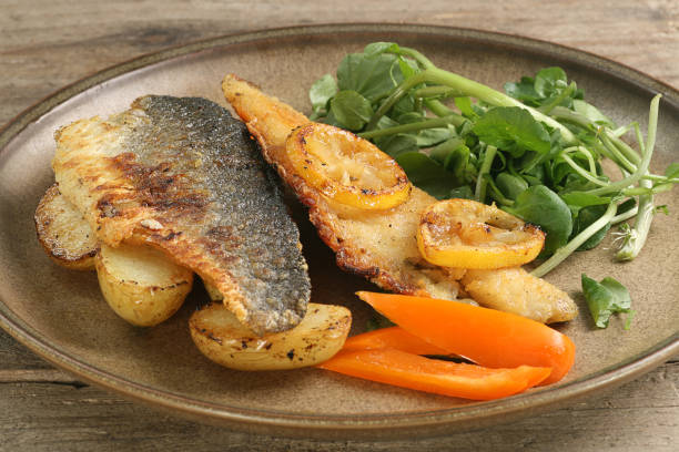 istock Pan fried sea bass with fried potato 1413991823