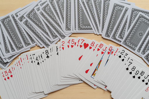 Poker cards with a high card combination. Close up of a gambler hand is holding playing cards in casino