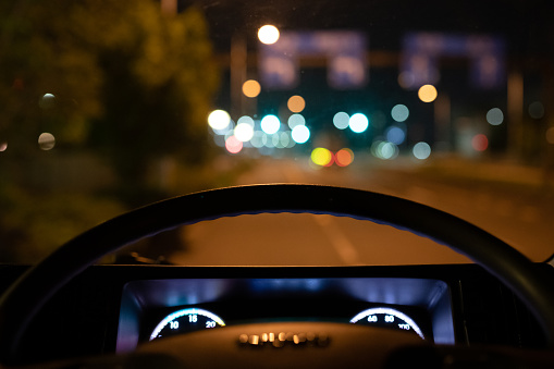 Night road seen from the driver's seat of a car