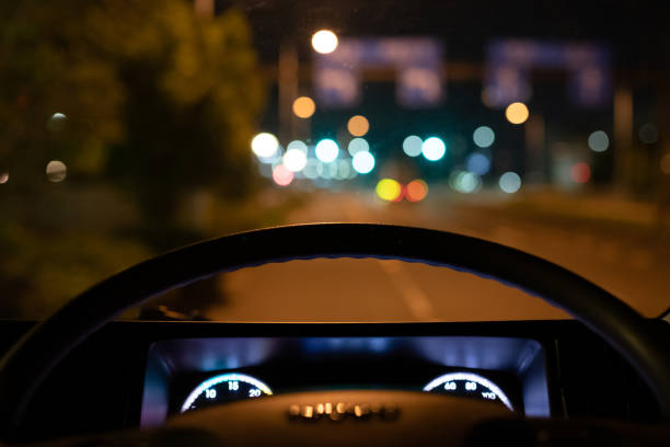 Night road seen from the driver's seat of a car Night road seen from the driver's seat of a car drivers seat stock pictures, royalty-free photos & images