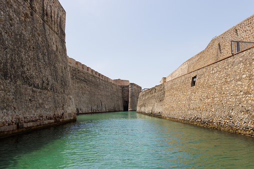 View from a tourist boat of the Royal Walls of Ceuta and its navigable moat, horizontal