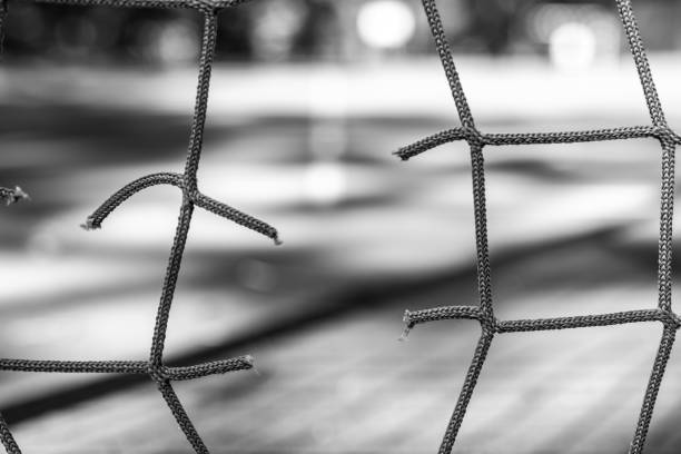 Net on the pitch. Broken mesh. No people. Krakow. Poland. Black and white