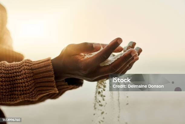 Closeup Pouring Sand Through Hands On The Beach During Sunset Man Holding Or Playing With Soft Soil Grains While It Runs Through Fingers Outside In Nature Near The Ocean In Summer With Copy Space Stock Photo - Download Image Now