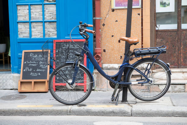 istock Bicycle chained to a post on the pavement outside a cafe 1413998728